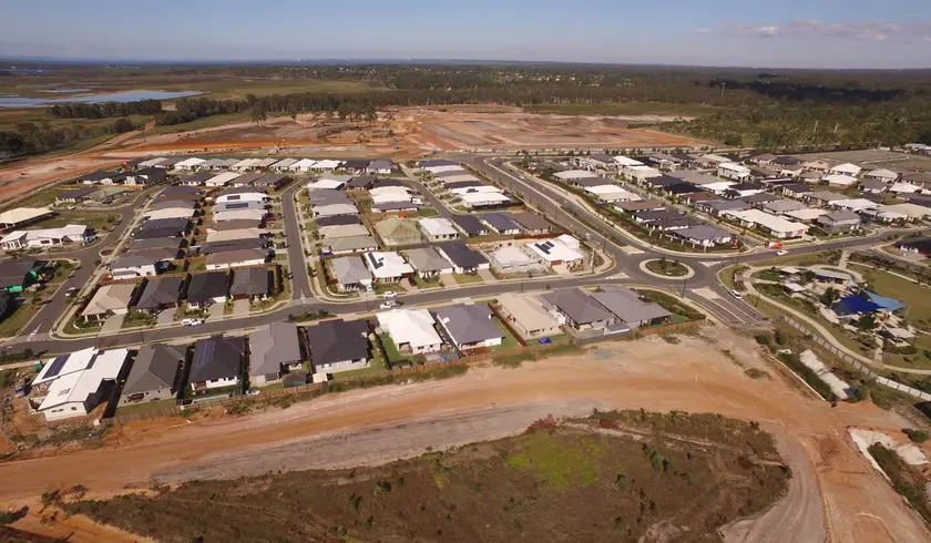 Aerial view of completed homes at North Harbour, Morayfield, beside earthworks for the next stage