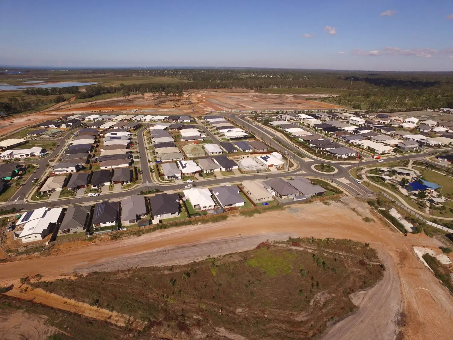 Aerial view of completed homes at North Harbour, Morayfield, beside earthworks for the next stage