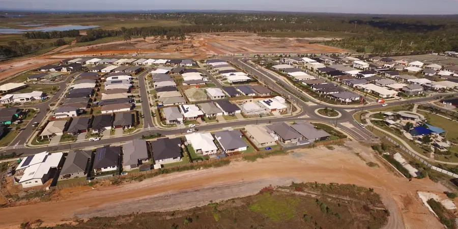 Aerial view of completed homes at North Harbour, Morayfield, beside earthworks for the next stage