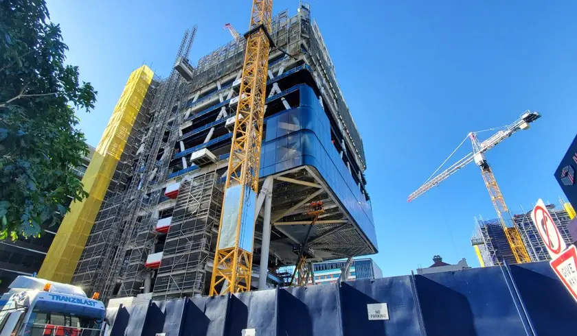 Jubilee Place under construction, its upper levels cantilevered over the street