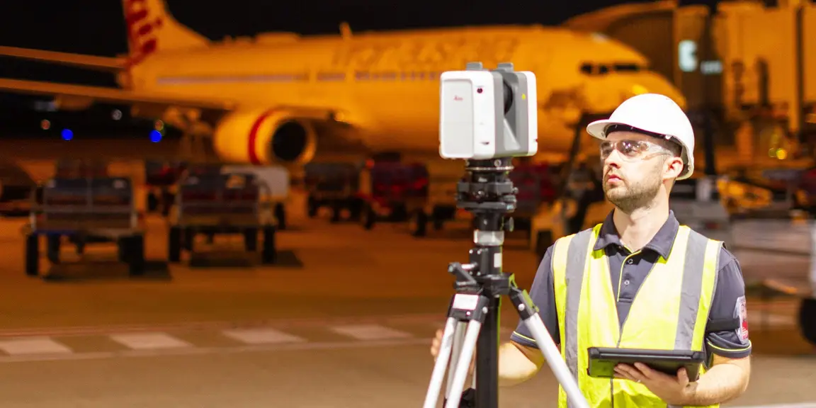 Land Solution Australia surveyor laser scanning an airport apron in Brisbane at night