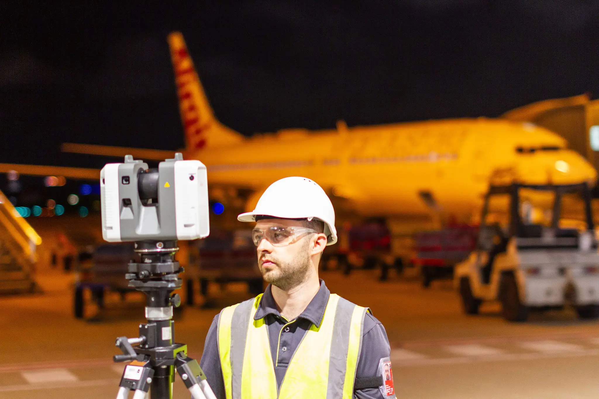Land Solution surveyor on site at Brisbane Airport, conducting laser scans on the tarmac