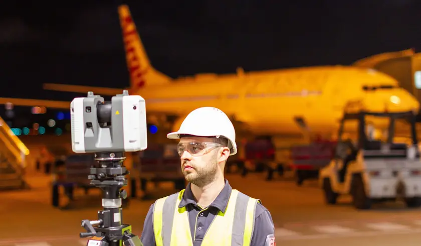 Land Solution surveyor on site at Brisbane Airport, conducting laser scans on the tarmac