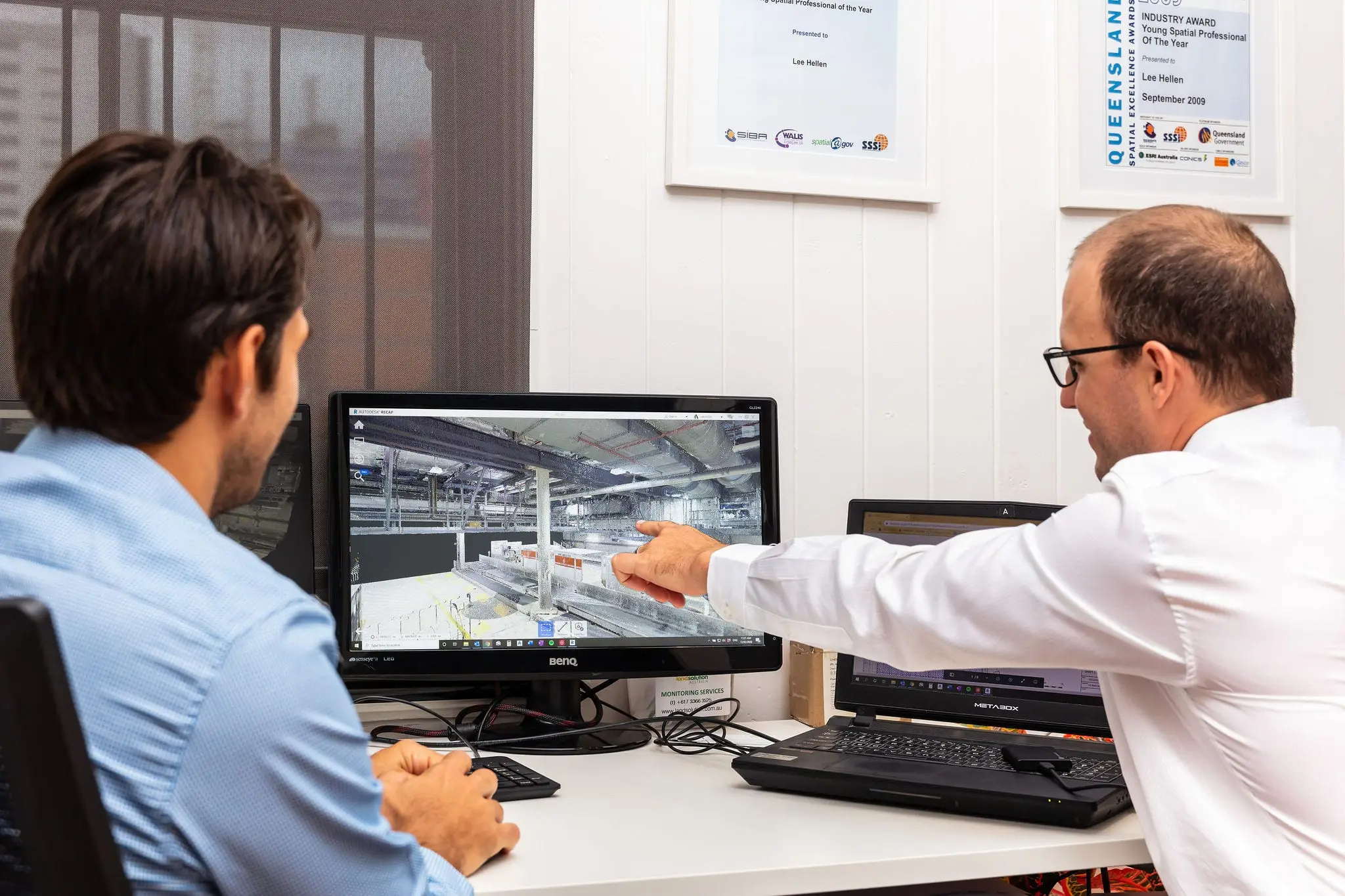 Land Solution Australia surveyors reviewing a laser-scanned BIM model in the Brisbane office