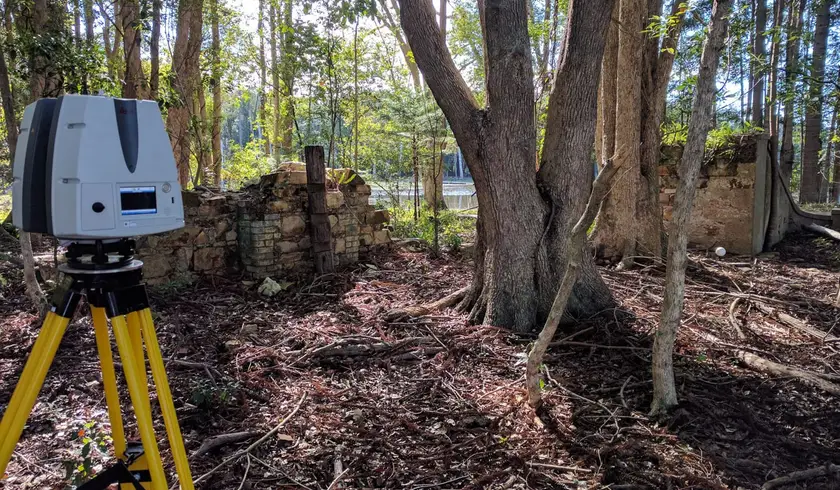 Laser scanner set up beside the stone ruins of the Moray-Fields settlement in North Harbour Heritage Park
