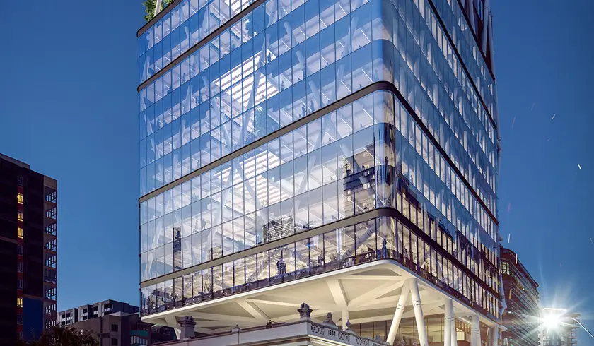 Render of Jubilee Place at night, its glass tower and white steel exoskeleton cantilevered over the heritage Jubilee Hotel