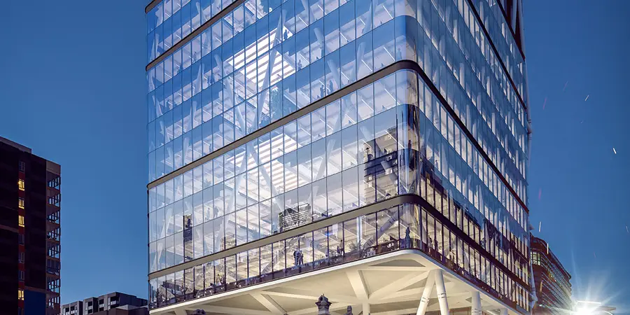 Render of Jubilee Place at night, its glass tower and white steel exoskeleton cantilevered over the heritage Jubilee Hotel
